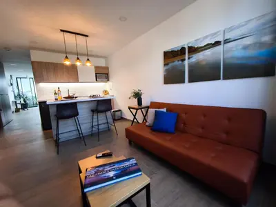 a living room with a couch and a kitchen at Florentina Living 302 A in Medellín
