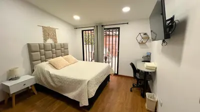 a bedroom with a bed and a television in it at Lindos Apartamentos con Terraza in Manizales