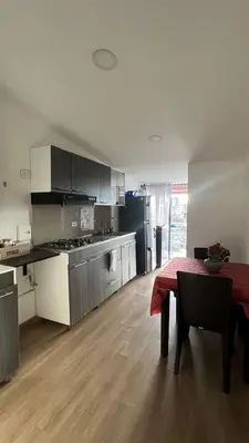 a large kitchen with a table and a kitchen with a tableablish at Lindos Apartamentos con Terraza in Manizales