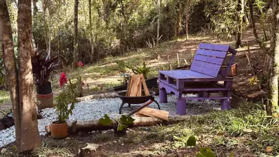 a blue chair and a bench in a garden at Casa Tikkun in Medellín