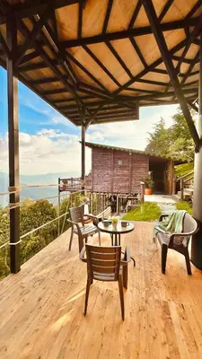 a patio with a table and chairs on a deck at Casa Tikkun in Medellín