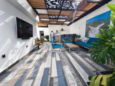 a living room with blue chairs and a flat screen tv at Florentina Living 401 in Medellín