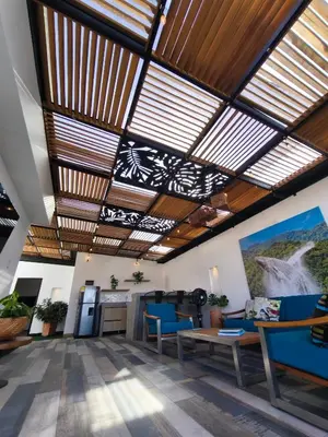 a living room with wooden ceilings and blue chairs at Florentina Living 401 in Medellín