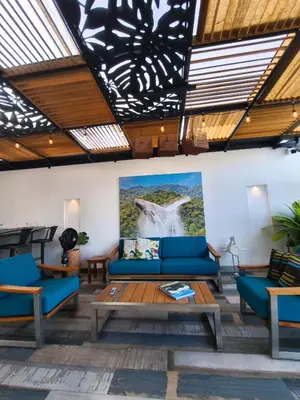 a living room with blue couches and a painting on the wall at Florentina Living 401 in Medellín