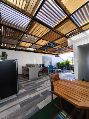 an outdoor patio with a wooden ceiling and a table at Florentina Living 401 in Medellín