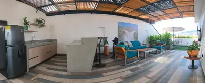 a kitchen with a refrigerator and a couch in a room at Florentina Living 401 in Medellín