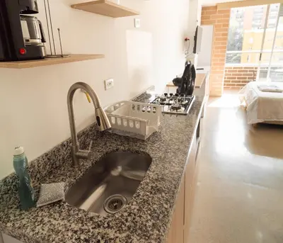 a kitchen counter with a sink in a kitchen at Apartamentos Montecarlo in Medellín