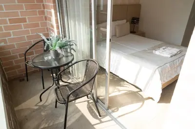a small room with a table and a bed at Apartamentos Montecarlo in Medellín