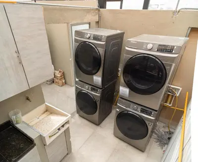 two washing machines sitting next to each other in a room at Apartamentos Montecarlo in Medellín