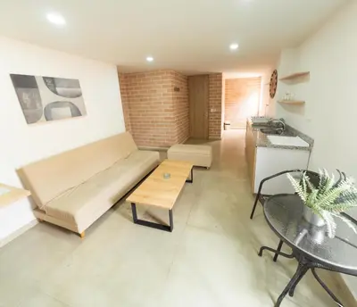 a living room with a couch and a table at Apartamentos Montecarlo in Medellín