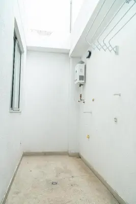 an empty room with a white wall and a window at Apartamentos Montecarlo in Medellín