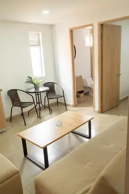 a living room with a couch and a table at Apartamentos Montecarlo in Medellín