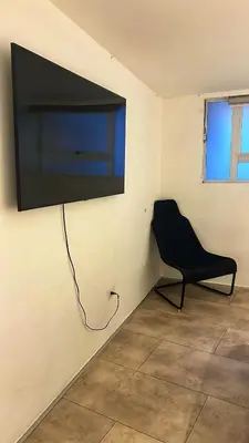 a black chair sitting in a room with a flat screen tv at Cómodo, amplio y relajante Apto, cerca a Cable plaza y sector Milán in Manizales