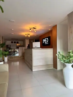a lobby with a mex sign on a counter at Hotel Med Llanogrande in Rionegro