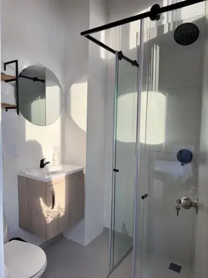 a bathroom with a shower and a toilet and a sink at Hotel Med Llanogrande in Rionegro