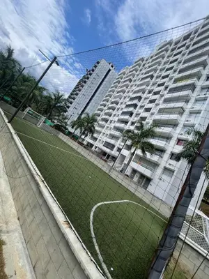a tennis court in front of a large building at Luxury Apartment Citadela de Sole Santa fe de Antioquia in Santa Fe de Antioquia