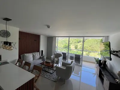a living room with a couch and a table at Luxury Apartment Citadela de Sole Santa fe de Antioquia in Santa Fe de Antioquia