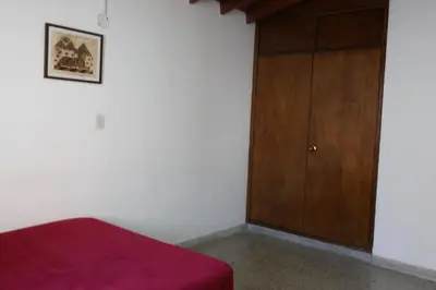 a bedroom with a bed and a wooden cabinet at Living Poblado Manila 301 D Habitación Doble in Medellín