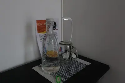 a bottle of water sitting on a black table at Living Poblado Manila 301 D Habitación Doble in Medellín