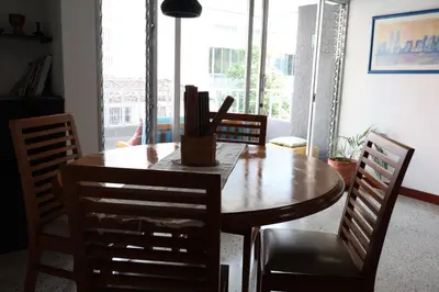 a dining room with a wooden table and chairs at Living Poblado Manila 301 D Habitación Doble in Medellín
