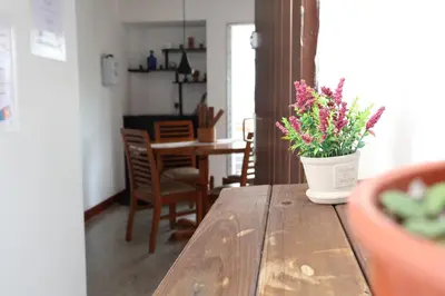 a vase of flowers sitting on a wooden table at Living Poblado Manila 301 D Habitación Doble in Medellín