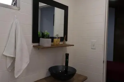 a bathroom with a black sink and a mirror at Living Poblado Manila 301 D Habitación Doble in Medellín