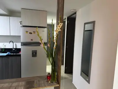 a kitchen with a vase of flowers on a counter at Apartamento Medellin con Jacuzzi privado in Medellín
