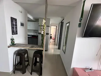 a kitchen with a counter and stools in a room at Apartamento Medellin con Jacuzzi privado in Medellín