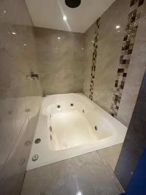 a white tub in a bathroom with a shower at Apartamento Medellin con Jacuzzi privado in Medellín