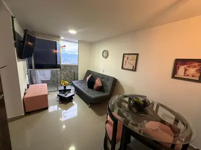 a living room with a couch and a glass table at Apartamento Medellin con Jacuzzi privado in Medellín
