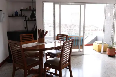 a dining room with a wooden table and chairs at Living Poblado Manila 301 E Habitación Doble in Medellín