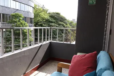 a couch sitting on a balcony with a view at Living Poblado Manila 301 E Habitación Doble in Medellín