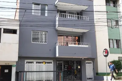 a man walking in front of a building at Living Poblado Manila 301 F Habitación Individual in Medellín
