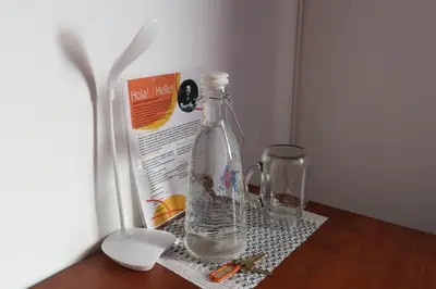 a bottle and two glasses sitting on a table at Living Poblado Manila 301 F Habitación Individual in Medellín