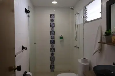 a bathroom with a shower with a toilet and a sink at Living Poblado Manila 301 F Habitación Individual in Medellín
