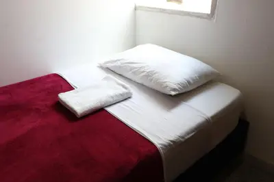 a white bed with two pillows on top of it at Living Poblado Manila 301 F Habitación Individual in Medellín
