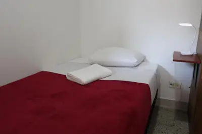 a bed with two white pillows on top of it at Living Poblado Manila 301 F Habitación Individual in Medellín