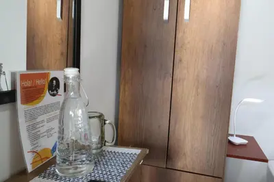 a bottle of water sitting on a table next to a door at Living Poblado Manila 301 F Habitación Individual in Medellín
