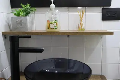 a glass sink sitting on a counter in a bathroom at Living Poblado Manila 301 F Habitación Individual in Medellín