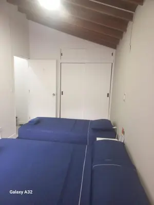 a row of blue beds in a room at Living Poblado Manila 301 G Hab Doble con Baño in Medellín