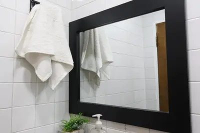 a mirror above a sink in a bathroom at Living Poblado Manila 301 G Hab Doble con Baño in Medellín
