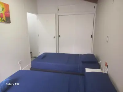a room with two blue beds and two closets at Living Poblado Manila 301 G Hab Doble con Baño in Medellín