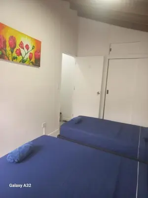 a bedroom with a bed with a painting on the wall at Living Poblado Manila 301 G Hab Doble con Baño in Medellín