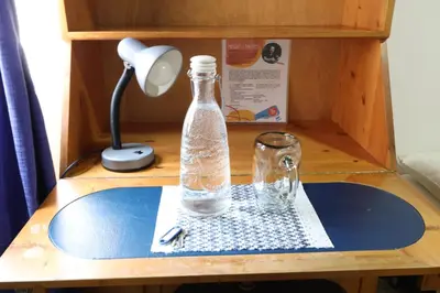a bottle of water on a table with a lamp at Living Poblado Manila 301 B Habitación Individual in Medellín