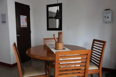 a dining room table with chairs and a mirror at Living Poblado Manila 301 B Habitación Individual in Medellín