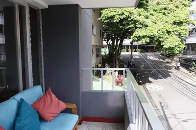 a blue couch sitting on the balcony of a building at Living Poblado Manila 301 B Habitación Individual in Medellín