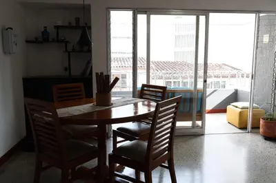 a wooden table and chairs in a room with a window at Living Poblado Manila 301 C Habitación Individual in Medellín