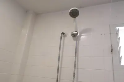 a shower with a shower head in a bathroom at Living Poblado Manila 301 C Habitación Individual in Medellín