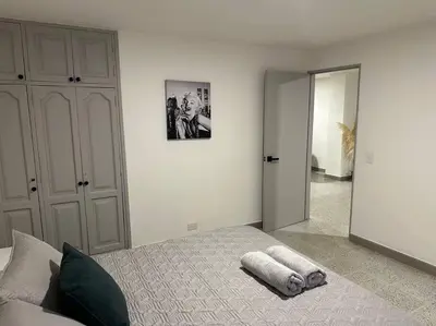 a bedroom with a bed with a towel on it at Apartamento nuevo Laureles-Estadio 900 mbps wifi barrio tranquilo cerca a la 70 in Medellín
