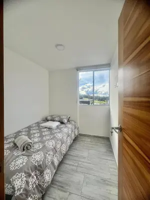 a bedroom with a bed and a large window at Apartamento familiar y de descanso in Rionegro